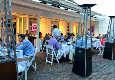 The brick patio of Maison Vivienne, which overlooks Southampton’s Main Street but is hidden behind hedges, was lively on a pleasant Tuesday evening.