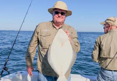 John Brosnan held a fluke caught in more pleasant weather aboard Breakaway, a charter boat out of Montauk. As of last month, all party and charter boats are now required to file electronic catch reports on certain fish, including fluke.