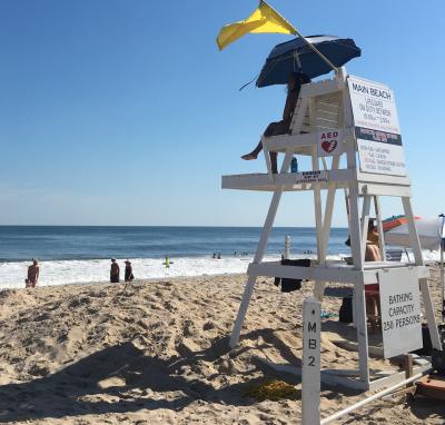 Lifeguards kept watch on the ocean at Main Beach in East Hampton on Wednesday afternoon, where they were flying a yellow flag, not because of the shark bites in the water off Fire Island, but because of rough conditions.