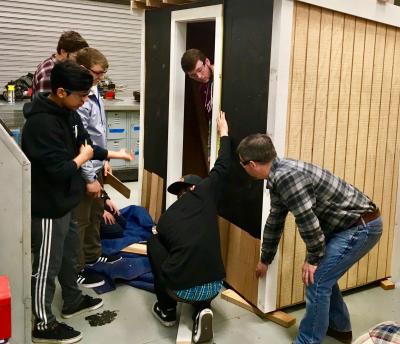 Andrew Rigby, right, the technology and manufacturing teacher at East Hampton High School, gave a lesson on shingling the exterior of a building, as part of a building trades class.