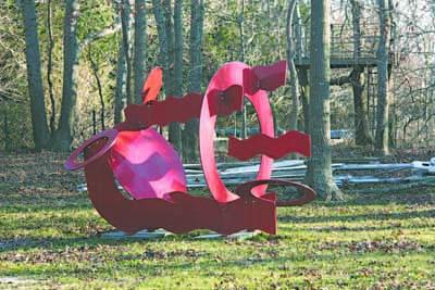 Hans Vandebovenkamp’s sculpture “Red Circles and Waves” is among many on the grounds.