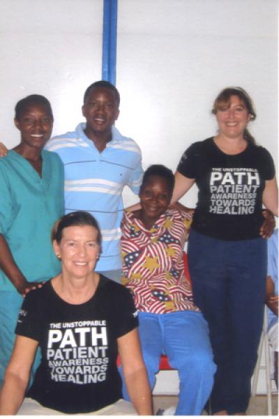 Mitten Wainwright, seated at left, and Liz Lattuga, standing at right, spent a recent week in Haiti showing hospital caregivers techniques for maintaining their own health.