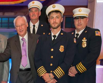 Elbert T. Edwards, far left, at an East Hampton Fire Department dinner in April, died last Thursday.