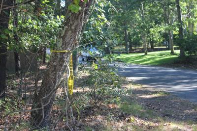 Police tape can be seen near the spot on Farm Lane in East Hampton where an 82-year-old man was found injured on Sunday following an apparent hit-and-run.