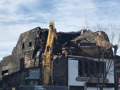 Keith Grimes Inc. worked to demolish the building at 84 Main Street in Sag Harbor, three days after a fire gutted it and undermined its structural integrity.