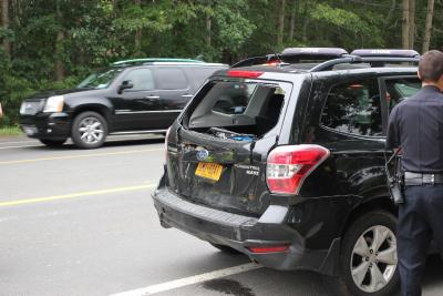 A utility truck rear-ended a Subaru Forester, which then hit the back of a school bus. No children were on board the bus.