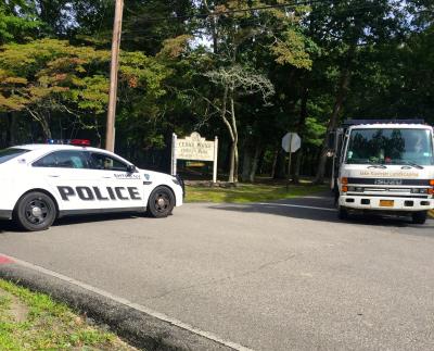 Police blocked Alewife Brook Road near the entrance to Cedar Point County Park while they investigate a death.