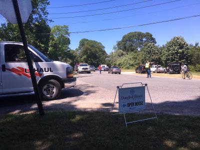 Traffic backed up at the circle as emergency workers closed down one lane of Route 114 as they dealt with the accident in the woods.