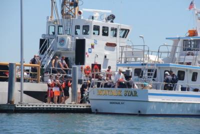 The Montauk Star docked at the Montauk Coast Guard station after it was escorted in with a man aboard who was in distress.