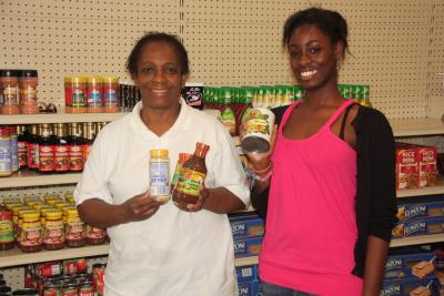 Rena Hewie Stoutt, seen here with her granddaughter, Alayah Hewie, holds some of her island goodies that are available at her new North Main Street store, Jamaican Specialties.