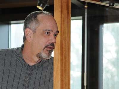 Len Bernard, listening during a 2011 town board meeting, will stay on as East Hampton Town's budget chief.