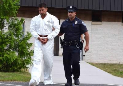 Sean P. Ludwick, a major real estate developer in Manhattan, was led out of the Southampton Town Police Department for his arraignment on Monday. He is accused of driving drunk in a crash that left his passenger, Paul Hansen, dead.