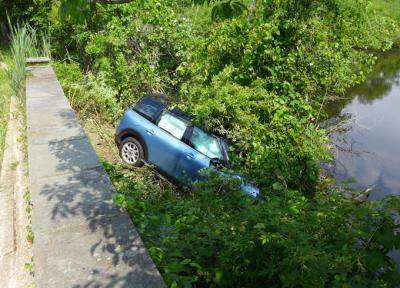 A Mini Cooper was apparently abandoned by its driver after it ran off the road in East Hampton Village and came to rest down an embankment in a Hook Pond tributary.