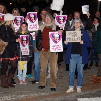 Protesters stood at the foot of Long Wharf in Sag Harbor Village Thursday night, one of 500 rallies nationwide promoted by the activist group MoveOn.