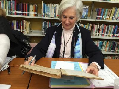 Eleanor Tritt, the Amagansett School superintendent, checked out a geography textbook from 1863 that once belonged to a student at the original Amagansett School, which was moved to the current school grounds recently.