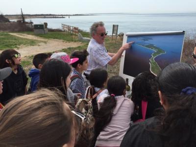 Tom Dwyer, a geologist who works for the Plum Island Animal Disease Center, showed aerial photos of the East End, including Plum Island, to children from John M. Marshall Elementary School during a 2015 field trip to the island.