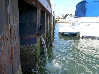 An East Hampton Town project would seek to block contaminants from reaching the surface of Three Mile Harbor.