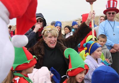 Joan Tulp wears a fur coat and a tiara to the East Hampton Main Beach Polar Bear Plunges.