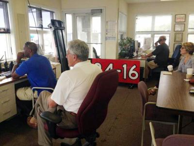 At East Hampton Airport on Monday morning, Town Supervisor Larry Cantwell, front, and Councilwoman Kathee Burke-Gonzalez, at right, joined Jemille Charlton, the airport manager, and Peter Boody, an airport staffer, to see how things stacked up as the first full weekend of an overnight curfew came to an end.