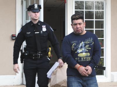 Gerson Mancilla, shown here being led away from East Hampton Town Justice Court on Sunday after being arraigned on a felony driving while intoxicated charge, was able to obtain a taxi driver’s license from the town earlier this year, despite a previous felony conviction.