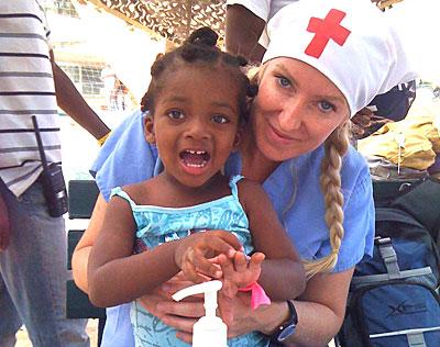 Alison Thompson with a Haitian orphan. Ms. Thompson will speak in Sag Harbor on July 15 about her experiences as a volunteer following several international disasters.