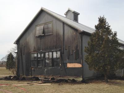 Firefighters put out a grass fire on Wednesday at the Hayground School in Bridgehampton that had reached a kitchen building and was climbing an outside wall.