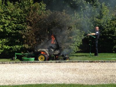 A Southampton Town police officer poured water from an outdoor hose onto the burning lawn mower.