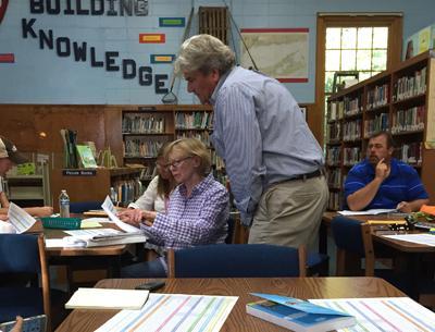 Roger Smith, a principal with BBS Architects and Engineers, assisted Pamela Bicket, a member of the Springs School facilities committee, at a meeting last year.