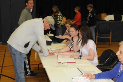 A voter signed in to cast his ballot in the Amagansett School District's annual budget vote and school board election.