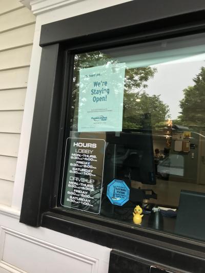 A sign at the drive-through window alerted customers that the bank will remain open.