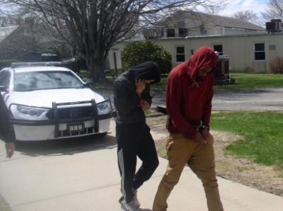 Donya Davis, in the red sweatshirt,and Juan Cano were arrested by East Hampton Town police Thursday on burglary charges.