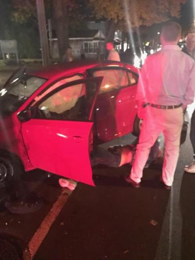 The driver of a Volkswagen Jetta that slammed into parked cars in Bridgehampton lay on the ground on Main Street Wednesday night.