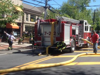 Firefighters on Montauk Highway in Bridgehampton, which was closed to traffic on Saturday morning as a fire at World Pie restaurant was brought under control.