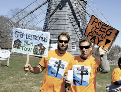 Protesters, including Ben Forst, left, and Tom Piacentine, gathered at Hook Mill Saturday to call on PSEG Long Island to bury high-voltage electrical transmission lines and remove new poles.