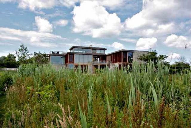 The house offers long views toward the ocean from the second floor living areas and the third floor office and roof deck. Below, James Merrell pauses during a recent visit.