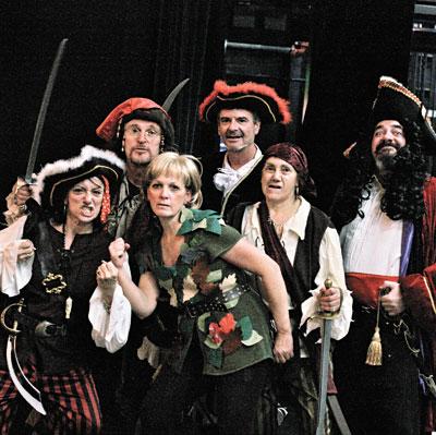 Jayne Freedman, surrounded by pirates, including Josh Gladstone’s Captain Hook (far right), plays Peter Pan in the Springs Community Theater production tomorrow and Saturday at Guild Hall.