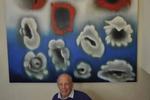 Mickey Straus was photographed at home last year with an art collection that features South Fork artists such as Ross Bleckner, above.