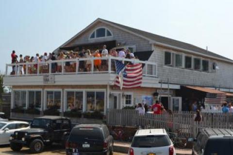 Happier times. The Sloppy Tuna in Montauk has reopened after sustaining floor damage Friday after a patron, showing off by hanging on an overhead sprinkler pipe, caused extensive flooding.