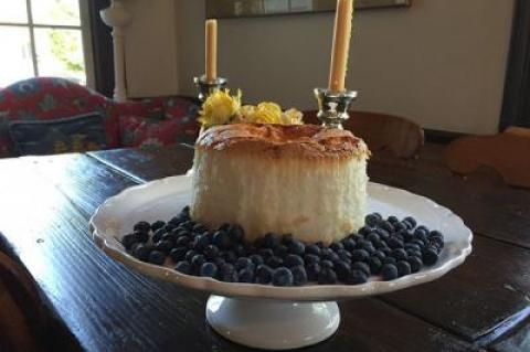 An angel food cake can be flavored with lemon, coffee, or other essences and served with blueberries, as in this version of the dessert classic.