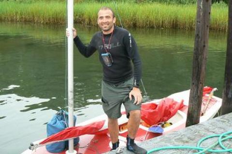 Norris Acosta stood with his Sunfish at Harbor Marina in Three Mile Harbor on Monday. He stopped off for supplies en route from Massachussetts to Brooklyn aboard the small sailboat.