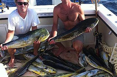 Jay Libath, left, and Eric Flaherty showed off some of the mahimahi they caught spearfishing near Atlantis Canyon on Monday.