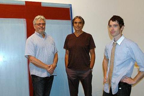 Dan Rizzie, left, with Tad Wiley and Ross Watts in front of Mr. Wiley’s painting during the installation of “Artists Choose Artists” on Aug. 18