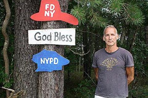 Peter Buchman beside his commemorative Sept. 11, 2001, piece on Route 114, a memorial that he did anonymously