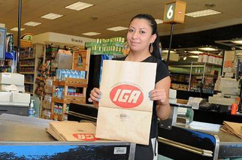 Christina Lescano, an employee of the Amagansett I.G.A., with some of the paper bags the store now uses exclusively.