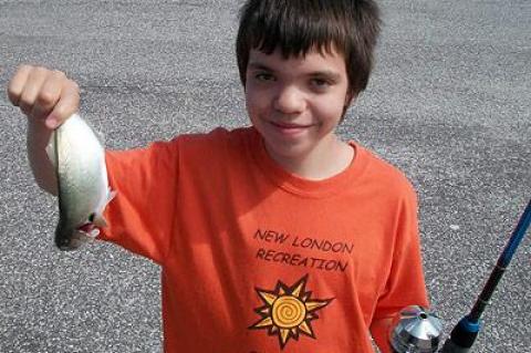 Bing Johnson displayed the snapper bluefish he caught to finish second in the 9-to-12-year-old division of the Harbor Marina snapper derby on Saturday.