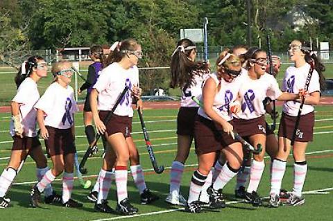 Meghan Dombkowski (with head bowed) was feted following her successful penalty stroke in the first half of Friday’s field hockey game here with Greenport-Southold.