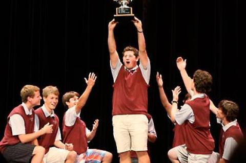 Cameron Yusko hoisted the Long Island trophy the golf team won last spring as his fall teammates knelt worshipfully.