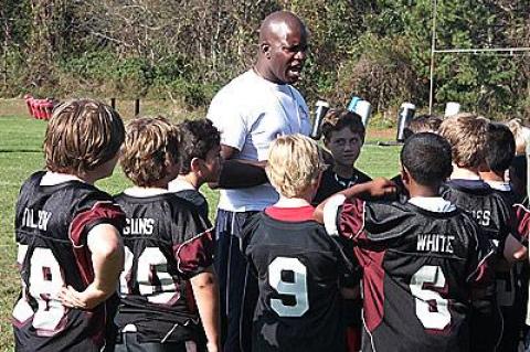 East Hampton’s 10-year-olds were encouraged by their coach, Ron White, before taking the field in a P.A.L. game  here Sunday.