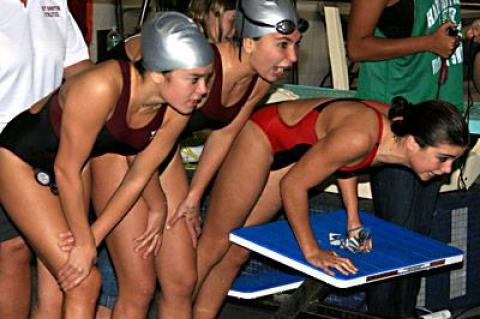 Morgan German, Carly Drew, and Lilah Minetree cheered on Maddie Minetree, whose swift anchor leg helped East Hampton to a second-place finish in the 400 freestyle relay, the final event of the League III championships at Hauppauge High School Friday.