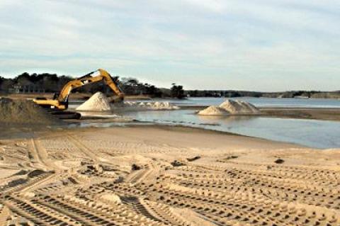 An excavator from the Bistrian Materials company dug sand from the south end of Georgica Pond during the week under contract with the town trustees.